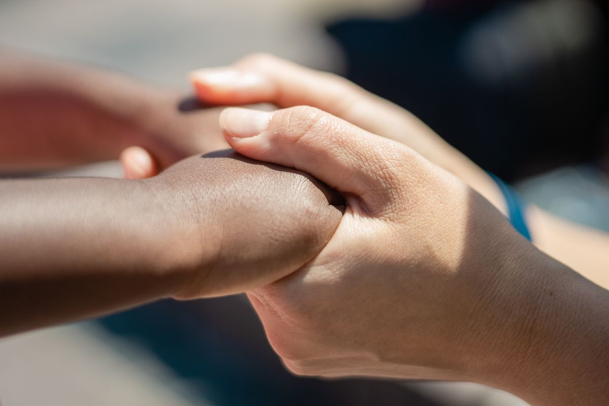 Hands joined together, symbolizing community